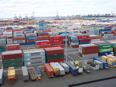 Aerial view of a container yard with stacked shipping containers awaiting documentation